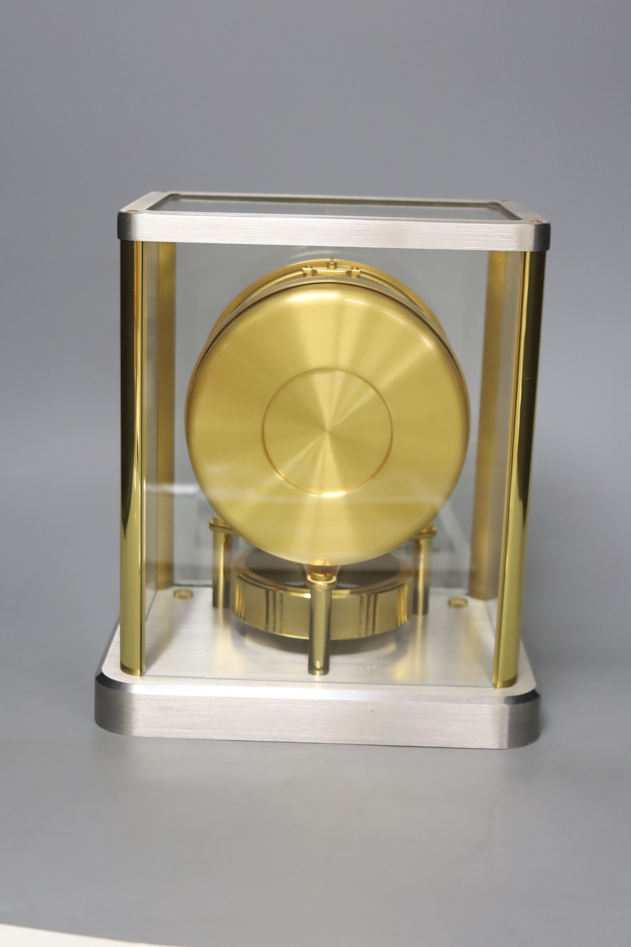 A Jaeger le Coultre Atmos mantel clock, in silvered and gilt metal glazed panelled case, height 23cm